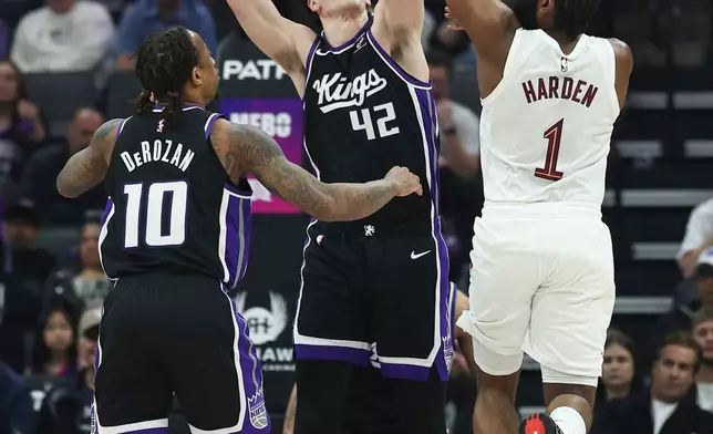 Cleveland Cavaliers guard James Harden (1) attempts to pass over Sacramento Kings center Maxime Raynaud (42) during the first half of an NBA basketball game Saturday, Feb. 7, 2026, in Sacramento, Calif. (AP Photo/Sara Nevis)