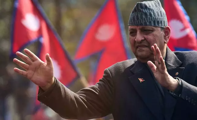 Former King Gyanendra Shah waves to his supporters upon his arrival at Tribhuvan International Airport in Kathmandu, Nepal, Friday, Feb. 13, 2026. (AP Photo/Niranjan Shrestha)