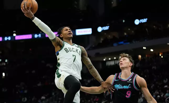 Milwaukee Bucks' Kevin Porter Jr. (7) drives to the basket against Miami Heat's Pelle Larsson during the first half of an NBA basketball game Tuesday, Feb. 24, 2026, in Milwaukee. (AP Photo/Aaron Gash)