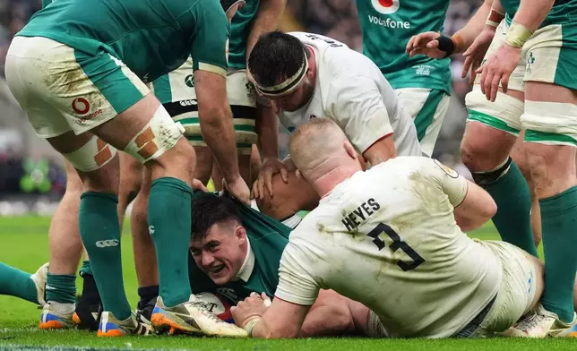 Ireland's Dan Sheehan, center, celebrates after scoring a try during the Six Nations rugby union match between England and Ireland in London, England, Saturday, Feb. 21, 2026. (AP Photo/Alastair Grant)