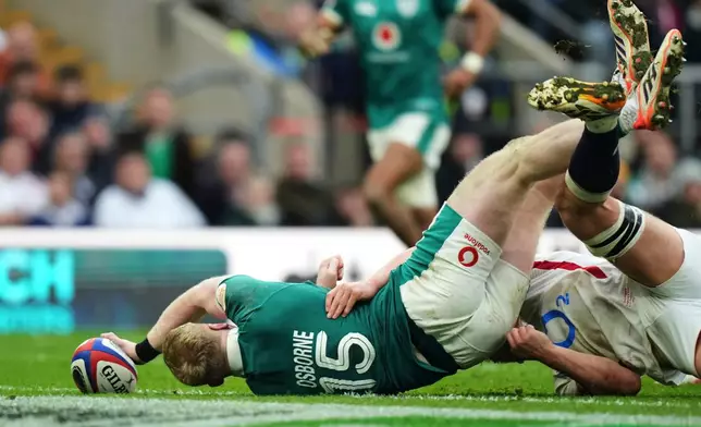 Ireland's Jamie Osborne scores a try during the Six Nations rugby union match between England and Ireland in London, England, Saturday, Feb. 21, 2026. (AP Photo/Alastair Grant)
