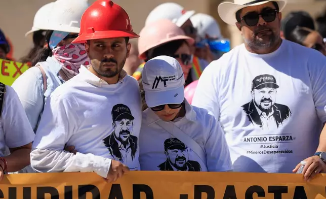Relatives of Antonio Esparza, one of 10 mine workers abducted in neighboring Sinaloa state, during protest march in Hermosillo, Mexico, Saturday, Feb. 14, 2026. (AP Photo/Luis Gutierrez)