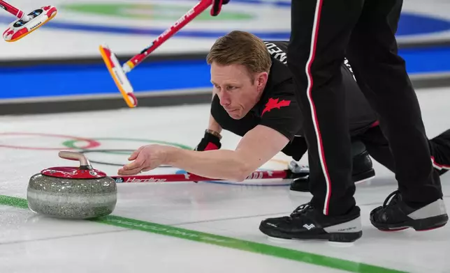 Canada's Marc Kennedy in action during the men's curling round robin session against Sweden, at the 2026 Winter Olympics, in Cortina d'Ampezzo, Italy, Friday, Feb. 13, 2026. (AP Photo/Misper Apawu)