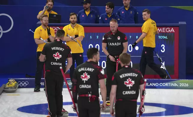 Canada's Brad Jacobs, Marc Kennedy, Brett Gallant, and Ben Hebert in action during the men's curling round robin session against Sweden, at the 2026 Winter Olympics, in Cortina d'Ampezzo, Italy, Friday, Feb. 13, 2026. (AP Photo/Misper Apawu)