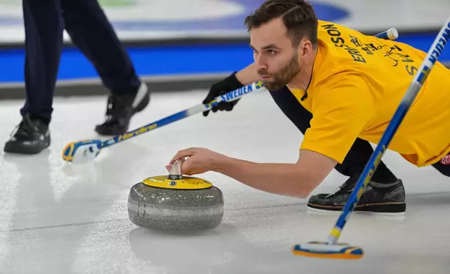 Sweden's Oskar Eriksson in action during the men's curling round robin session against Canada, at the 2026 Winter Olympics, in Cortina d'Ampezzo, Italy, Friday, Feb. 13, 2026. (AP Photo/Misper Apawu)