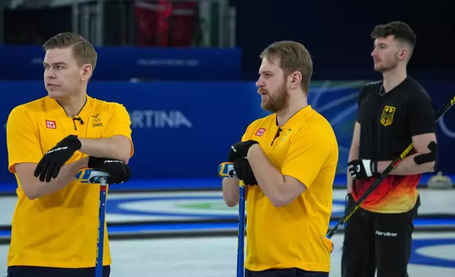 Sweden's Rasmus Wranaa and Christoffer Sundgren look on during the men's curling round robin session against Canada, at the 2026 Winter Olympics, in Cortina d'Ampezzo, Italy, Friday, Feb. 13, 2026. (AP Photo/Misper Apawu)