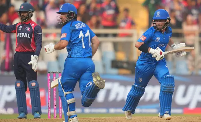 Italy's Anthony Mosca, left, Justin Mosca, right, run between the wickets as they bat during the T20 World Cup cricket match between Italy and Nepal in Mumbai, India, Thursday, Feb. 12, 2026. (AP Photo/Rafiq Maqbool)