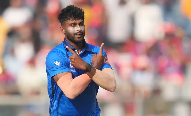 Italy's Crishan Kalugamage celebrates the wicket of Nepal's Gulshan Jha during the T20 World Cup cricket match between Italy and Nepal in Mumbai, India, Thursday, Feb. 12, 2026. (AP Photo/Rafiq Maqbool)