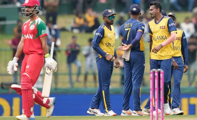 Sri Lanka's Dushmantha Chameera, right, celebrates with teammates the wicket of Oman's Captain Jatinder Singh, left, during the T20 World Cup cricket match between Oman and Sri Lanka in Pallekele, Sri Lanka, Thursday, Feb. 12, 2026. (AP Photo/Eranga Jayawardena)