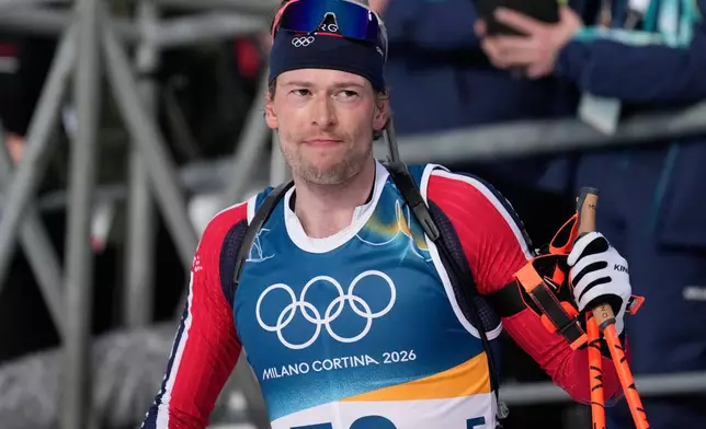 Sturla Holm Laegreid, of Norway, reacts in the finish area of the men's 10-kilometer sprint biathlon race at the 2026 Winter Olympics in Anterselva, Italy, Friday, Feb. 13, 2026. (AP Photo/Mosa'ab Elshamy)