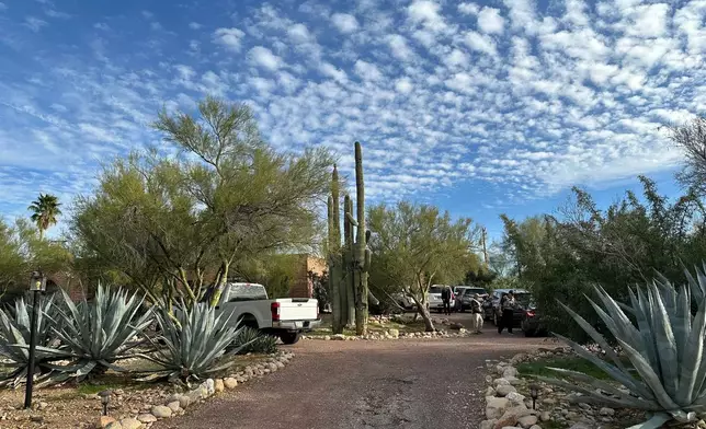 Law enforcement officers are present outside the home of Nancy Guthrie, the mother of "Today" host Savannah Guthrie, near Tucson, Ariz., Monday, Feb. 2, 2026. (AP Photo/Sejal Govindarao)