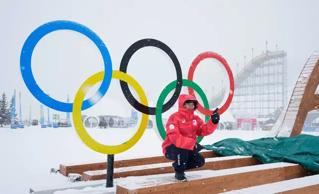 Japan's Goshin Fujiki poses for a photo in front of the Olympic rings at the 2026 Winter Olympics, in Livigno, Italy, Wednesday, Feb. 4, 2026. (AP Photo/Gregory Bull)