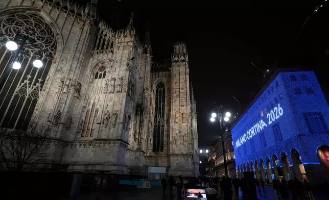 Milan Cortina 2026 is projected on the facade of a building in front of the Duomo gothic cathedral, in Milan, Italy, Wednesday, Jan. 28, 2026. (AP Photo/Luca Bruno)