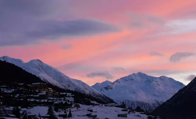 The sun sets over the mountains and the Livigno Valley prior to the Milano Cortina 2026 Winter Olympic Games opening ceremony in Livigno, Italy on Friday, Feb. 6, 2026. (Sean Kilpatrick/The Canadian Press via AP)