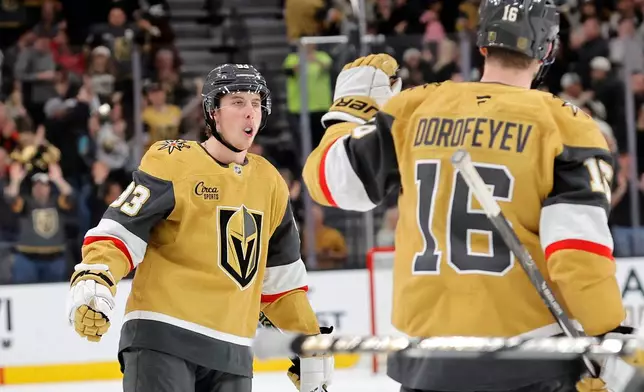 Vegas Golden Knights right wing Mitch Marner, left, is congratulated by right wing Pavel Dorofeyev (16) after scoring against the Seattle Kraken during the second period of an NHL hockey game Saturday Jan. 31, 2026, in Las Vegas. (AP Photo/Steve Marcus)