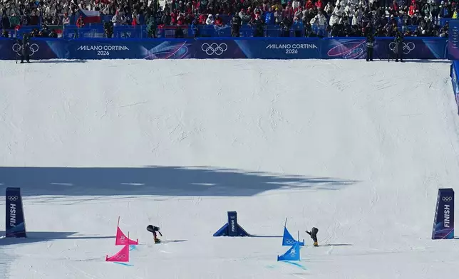 Austria's Sabine Payer, left, beats out Czechia's Ester Ledecka during the women's snowboarding parallel giant slalom finals at the 2026 Winter Olympics, in Livigno, Italy, Sunday, Feb. 8, 2026. (AP Photo/Gregory Bull)