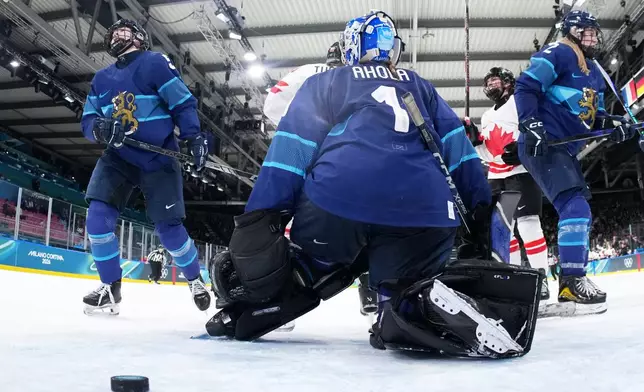 Canada's Emily Clark, second right, celebrates after scoring her side's sixth goal during a preliminary round match of women's ice hockey between Finland and Canada at the 2026 Winter Olympics, in Milan, Italy, Thursday, Feb. 12, 2026. (Sun Fei/Pool Photo via AP)