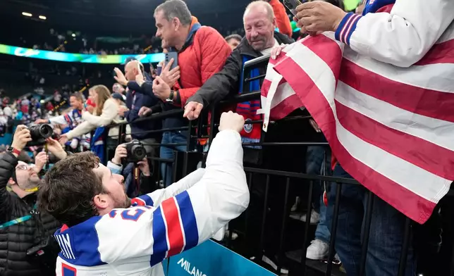United States' Dylan Larkin (21) celebrates with fans after the men's ice hockey gold medal game between Canada and the United States at the 2026 Winter Olympics, in Milan, Italy, Sunday, Feb. 22, 2026. (AP Photo/Hassan Ammar)