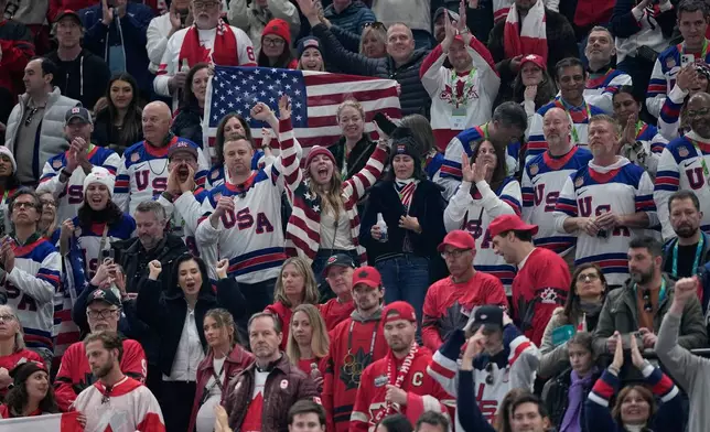 United States fans cheer after a men's ice hockey gold medal game between Canada and the United States at the 2026 Winter Olympics, in Milan, Italy, Sunday, Feb. 22, 2026. (AP Photo/Petr David Josek)