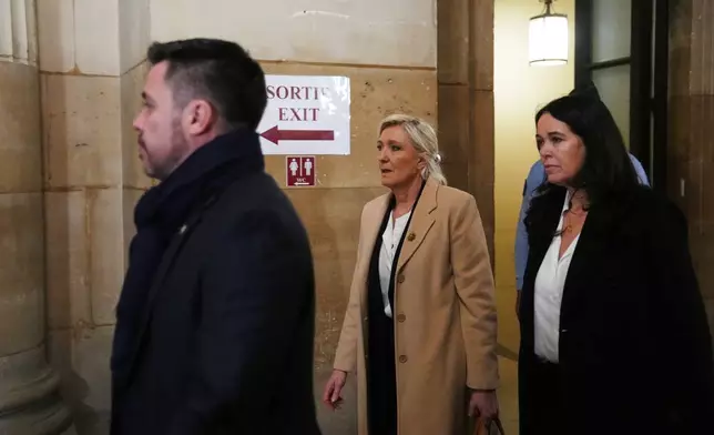 Far-right leader Marine Le Pen, center, arrives for her appeal trial, in Paris, France, Wednesday, Feb. 11, 2026. (AP Photo/Aurelien Morissard)