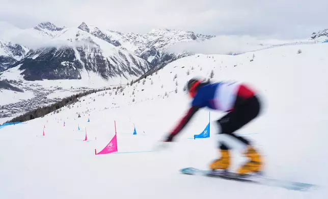 Bulgaria's Alexander Krashniak practices during a snowboard parallel giant slalom training session at the 2026 Winter Olympics, in Livigno, Italy, Friday, Feb. 6, 2026. (AP Photo/Gregory Bull)