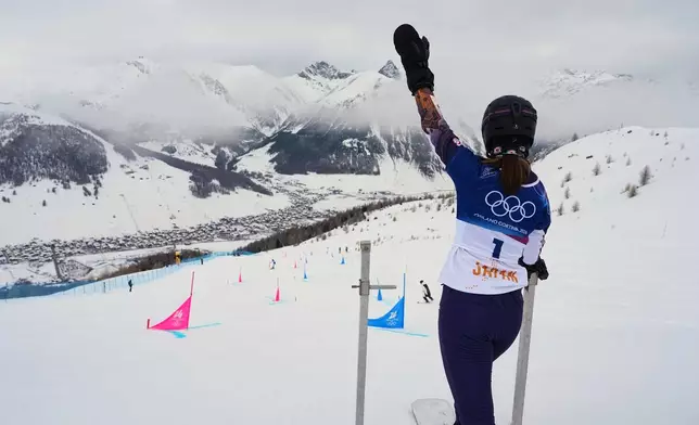Japan's Tsubaki Miki waves to coaches during a snowboard parallel giant slalom training session at the 2026 Winter Olympics, in Livigno, Italy, Friday, Feb. 6, 2026. (AP Photo/Gregory Bull)