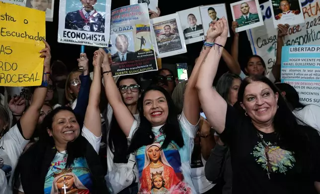 From left, opposition members Dignora Hernández, María Oropeza and Catalina celebrate with supporters after their release from custody near El Helicoide, the Venezuelan intelligence headquarters and detention center, in Caracas, Venezuela, Sunday, Feb. 8, 2026. (AP Photo/Ariana Cubillos)