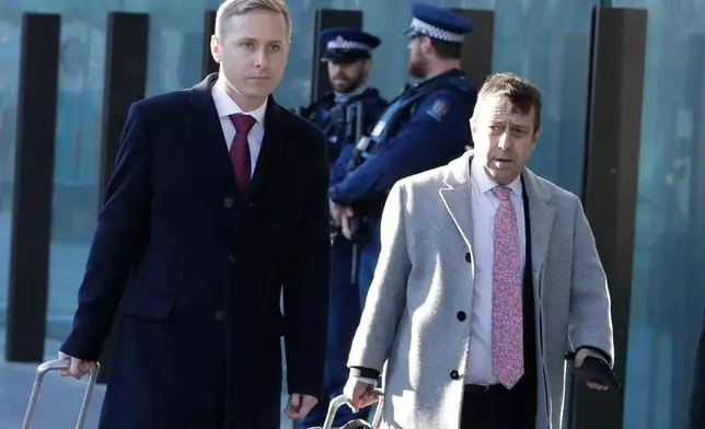 FILE - Jonathan Hudson, left, and Shane Tait, then defense lawyers for Brenton Tarrant, arrive at the Christchurch District Court in Christchurch, New Zealand, Aug. 15, 2019. (AP Photo/Mark Baker, File)