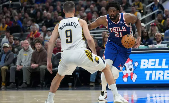 Philadelphia center Joel Embiid (21) looks to move around Indiana guard T.J. McConnell (9) during the first half of an NBA basketball game in Indianapolis, Tuesday, Feb. 24, 2026. (AP Photo/AJ Mast)