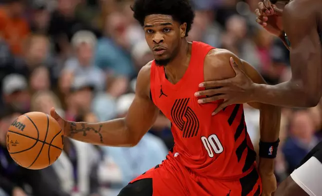 Portland Trail Blazers guard Scoot Henderson (00) drives to the basket during the first half of an NBA basketball game against the Utah Jazz, Thursday, Feb. 12, 2026, in Salt Lake City. (AP Photo/Tyler Tate)