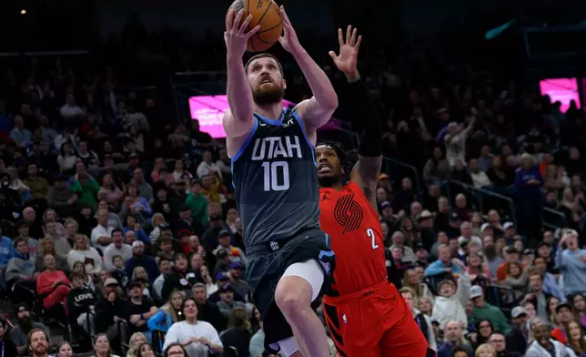 Utah Jazz guard Svi Mykhailiuk (10) goes to the basket for a layup guarded by Portland Trail Blazers guard Caleb Love (2) during the second half of an NBA basketball game, Thursday, Feb. 12, 2026, in Salt Lake City. (AP Photo/Tyler Tate)