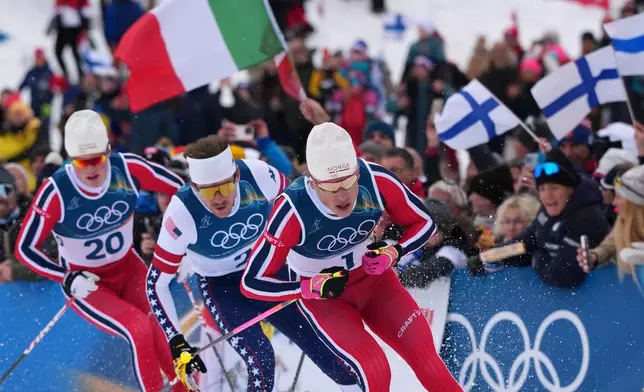 Johannes Hoesflot Klaebo, of Norway, from right, Ben Ogden, of the United States, and Oskar Opstad Vike, of Norway, compete in the final of the cross-country skiing men's sprint classic at the 2026 Winter Olympics, in Tesero, Italy, Tuesday, Feb. 10, 2026. (AP Photo/Kirsty Wigglesworth)