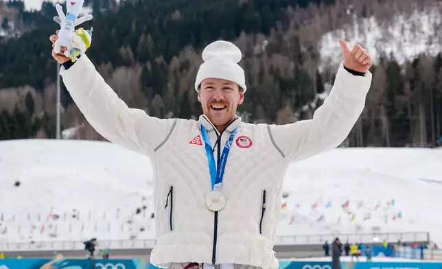 Ben Ogden, of the United States, poses after winning the silver medal in the cross-country skiing men's sprint classic at the 2026 Winter Olympics, in Tesero, Italy, Tuesday, Feb. 10, 2026. (AP Photo/Evgeniy Maloletka)