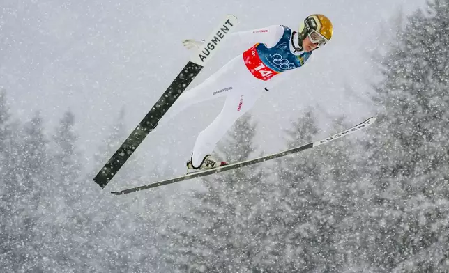 Stefan Rettenegger, of Austria, soars through the air during the nordic combined team sprint at the 2026 Winter Olympics, in Predazzo, Italy, Thursday, Feb. 19, 2026. (AP Photo/Evgeniy Maloletka)