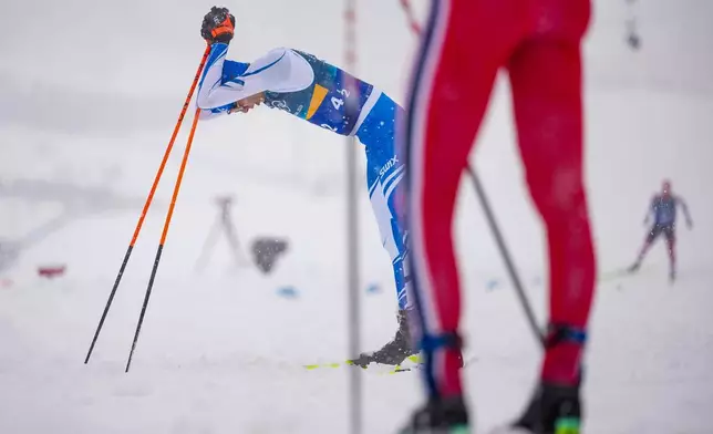 Eero Hirvonen, of Finland, reacts after crossing the finish line to win the silver medal in the nordic combined team sprint at the 2026 Winter Olympics, in Tesero, Italy, Thursday, Feb. 19, 2026. (AP Photo/Matthias Schrader)