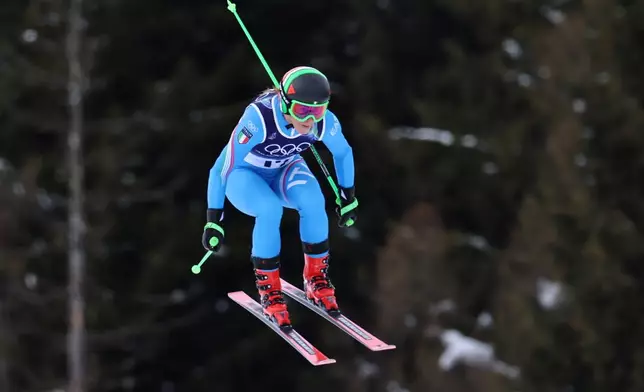 Italy's Sofia Goggia speeds down the course during an alpine ski, women's downhill official training, at the 2026 Winter Olympics, in Cortina d'Ampezzo, Italy, Friday, Feb. 6, 2026. (AP Photo/Marco Trovati)