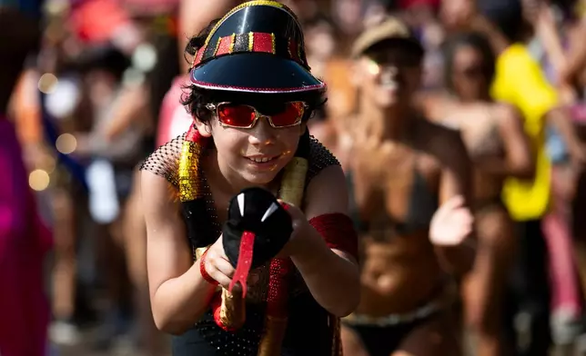 A child performs on stilts during the Amigos da Onca Carnival street party, in Rio de Janeiro, Saturday, Feb. 14, 2026. (AP Photo/Bruna Prado)