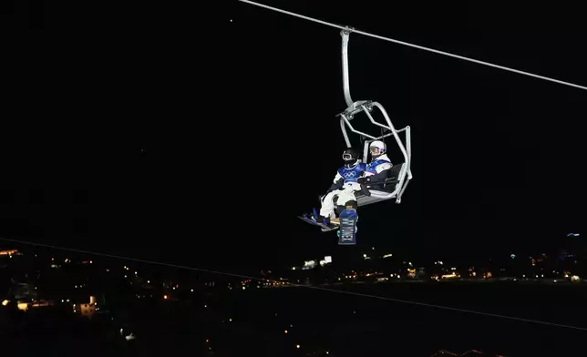 Japan's Ryusei Yamada, left, and Japan's Yuto Totsuka ride a chair lift during a snowboard halfpipe training session at the 2026 Winter Olympics, in Livigno, Italy, Sunday, Feb. 8, 2026. (AP Photo/Lindsey Wasson)
