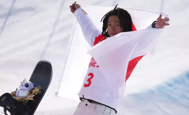 FILE - Gold medal winner Japan's Ayumu Hirano celebrates during the venue award ceremony for the men's halfpipe finals at the 2022 Winter Olympics, Friday, Feb. 11, 2022, in Zhangjiakou, China. (AP Photo/Matthias Schrader, File)