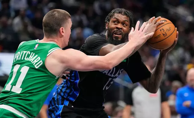 Dallas Mavericks forward Naji Marshall, right, looks for a shot as Boston Celtics' Payton Pritchard (11) defends in the first half of an NBA basketball game Tuesday, Feb. 3, 2026, in Dallas. (AP Photo/Tony Gutierrez)