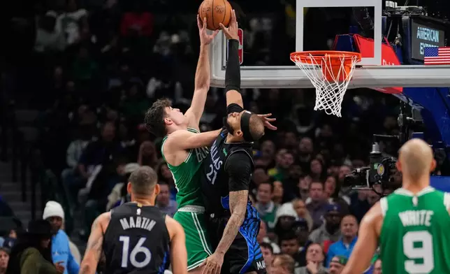 Boston Celtics guard Hugo Gonzalez, left, has his shot blocked b y Dallas Mavericks' Daniel Gafford (21) in the first half of an NBA basketball game Tuesday, Feb. 3, 2026, in Dallas. (AP Photo/Tony Gutierrez)