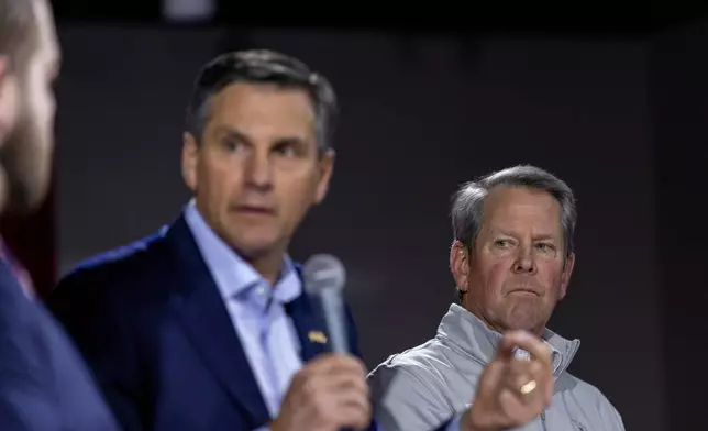 Georgia Gov. Brian Kemp, right, listens as Derek Dooley, left, a Republican candidate for Senate in Georgia, speaks during an Atlanta Young Republicans campaign event Thursday, Feb. 12, 2026, in Atlanta. (AP Photo/Alyssa Pointer)