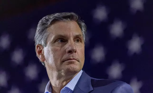 Derek Dooley, a Republican candidate for Senate in Georgia, listens to Georgia Gov. Brian Kemp, not pictured, speak during an Atlanta Young Republicans campaign event Thursday, Feb. 12, 2026, in Atlanta. (AP Photo/Alyssa Pointer)