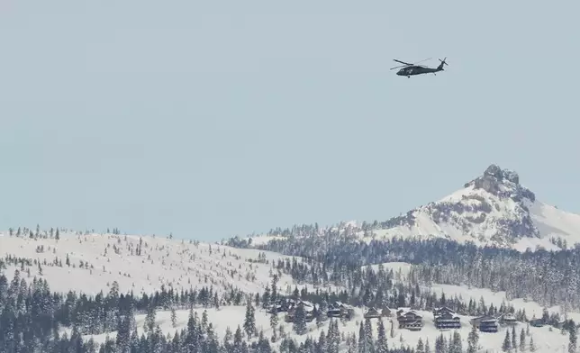 A U.S. Army Blackhawk helicopter flies toward the Castle Peak area as recovery efforts for a group of missing skiers continue in Truckee, Calif., Saturday, Feb. 21, 2026. (AP Photo/Godofredo A. Vásquez)