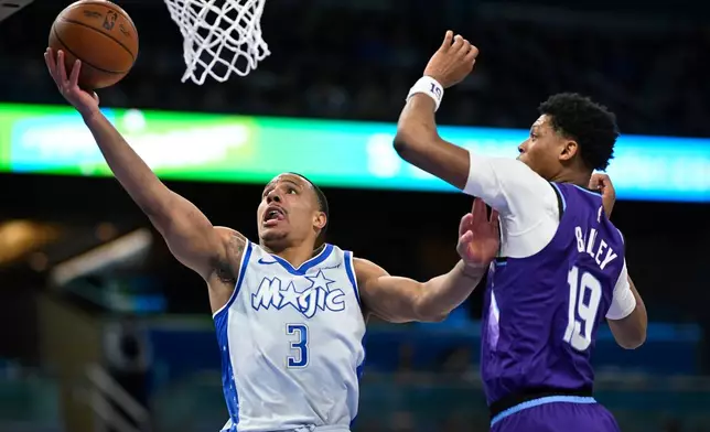 Orlando Magic guard Desmond Bane (3) goes up to shoot as Utah Jazz guard Ace Bailey (19) defends during the first half of an NBA basketball game, Saturday, Feb. 7, 2026, in Orlando, Fla. (AP Photo/Phelan M. Ebenhack)