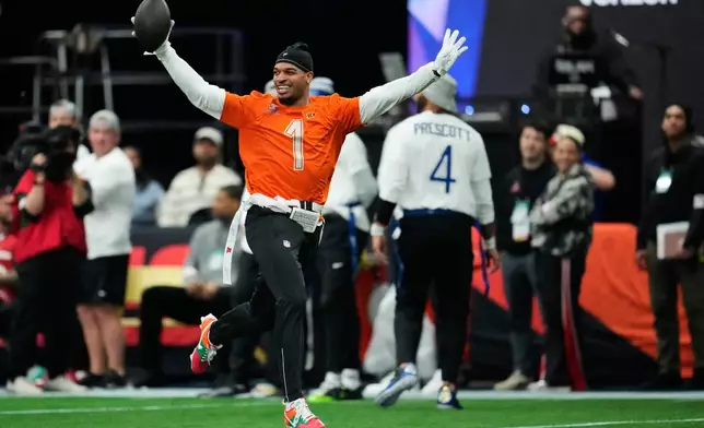 AFC wide receiver Ja'Marr Chase (1), of the Cincinnati Bengals, returns an interception for a touchdown against the NFC during the first half of the NFL Pro Bowl football game, Tuesday, Feb. 3, 2026, in San Francisco. (AP Photo/Godofredo A. Vásquez)