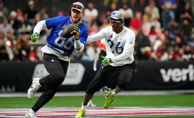 AFC tight end Dalton Kincaid (86), of the Buffalo Bills, runs with the ball while defended by NFC cornerback Nahshon Wright (26), of the Chicago Bears, during the first half of the NFL Pro Bowl football game, Tuesday, Feb. 3, 2026, in San Francisco. (AP Photo/Jeff Chiu)