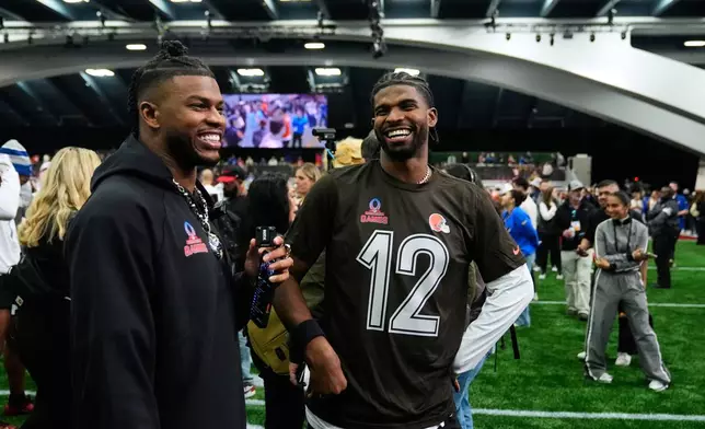 AFC quarterback Shedeur Sanders (12), of the Cleveland Browns, speaks with his brother Shilo Sanders, left, after the NFL Pro Bowl football game against the NFC, Tuesday, Feb. 3, 2026, in San Francisco. (AP Photo/Godofredo A. Vásquez)