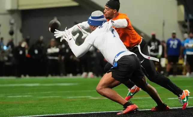 AFC wide receiver Ja'Marr Chase (1), of the Cincinnati Bengals, defends a pass intended for NFC running back Bijan Robinson (7), of the Atlanta Falcons, during the first half of the NFL Pro Bowl football game, Tuesday, Feb. 3, 2026, in San Francisco. (AP Photo/Jeff Chiu)
