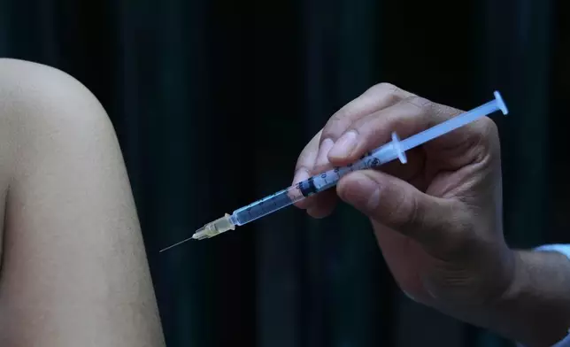 A health worker administers a dose of the measles vaccine outside a public hospital in Mexico City, Wednesday, Feb. 4, 2026. (AP Photo/Marco Ugarte)